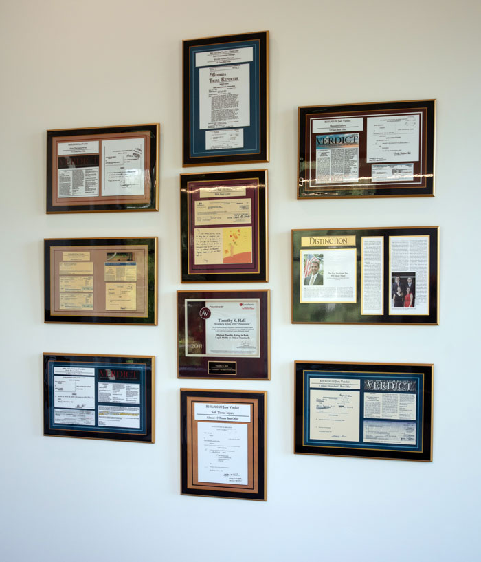 Photo of news clippings displayed on the wall in the firm's conference room